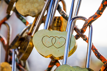 Image showing Padlocks symbols of love hanging on a fence