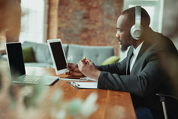 Image showing Businessman or student working from home while being isolated or keep quarantine \'cause of coronavirus COVID-19