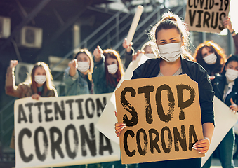 Image showing Young people in face masks protesting of stop coronavirus pandemic on the street