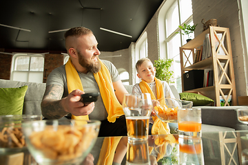 Image showing Excited family watching football, sport match at home, father and son