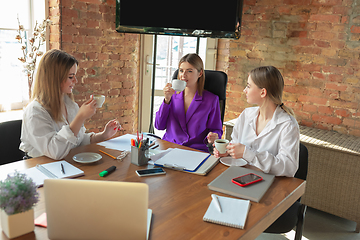 Image showing Business young caucasian woman in modern office with team