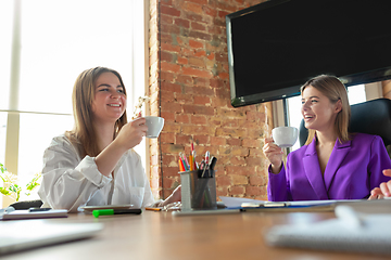 Image showing Business young caucasian woman in modern office with team