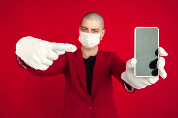 Image showing Portrait of young caucasian bald woman on red background