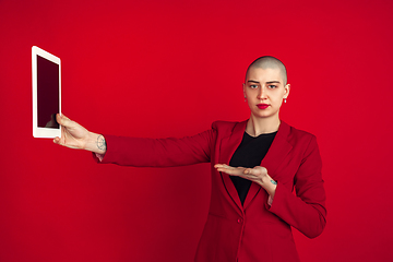 Image showing Portrait of young caucasian bald woman on red background