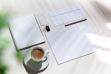 Image showing Creative and cozy workplace at home office, inspirational mock up with plant shadows on table surface