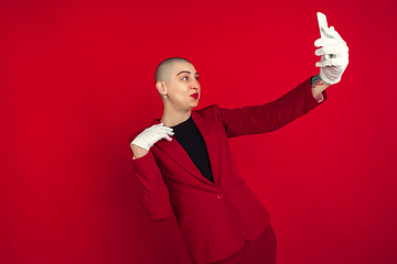 Image showing Portrait of young caucasian bald woman on red background