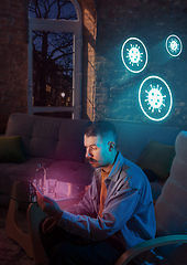 Image showing Shocked, upset and sad man using gadgets to get information of coronavirus pandemic spread