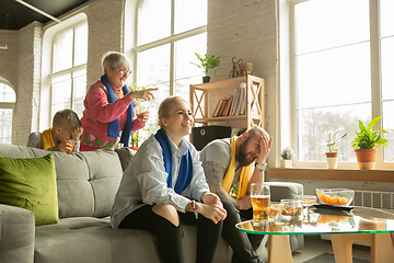 Image showing Excited family watching football, sport match at home, top view