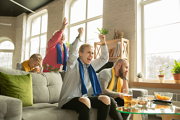 Image showing Excited family watching football, sport match at home, top view