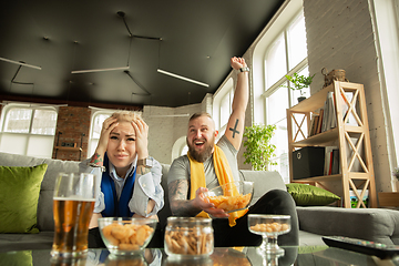 Image showing Excited family watching football, sport match at home, beautiful couple