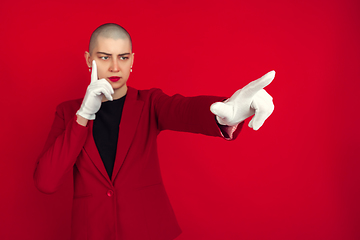 Image showing Portrait of young caucasian bald woman on red background