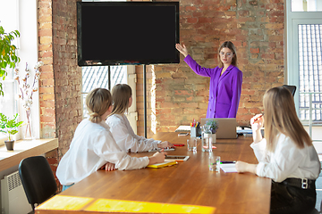 Image showing Business young caucasian woman in modern office with team