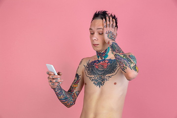 Image showing Portrait of young man with freaky appearance on pink background