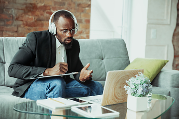 Image showing Businessman or student working from home while being isolated or keep quarantine \'cause of coronavirus COVID-19