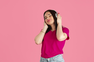 Image showing Monochrome portrait of young caucasian brunette woman on pink background