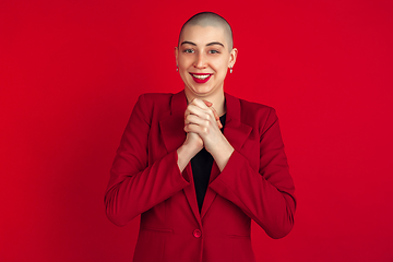 Image showing Portrait of young caucasian bald woman on red background