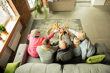 Image showing Excited family watching football, sport match at home, top view