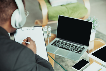 Image showing Top view of businessman or student working from home while being isolated or keep quarantine \'cause of coronavirus COVID-19