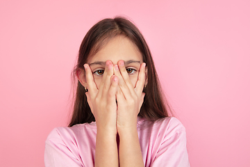 Image showing Caucasian little girl portrait isolated on pink studio background, emotions concept