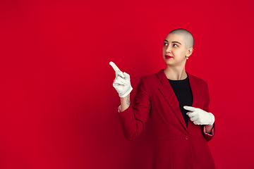 Image showing Portrait of young caucasian bald woman on red background