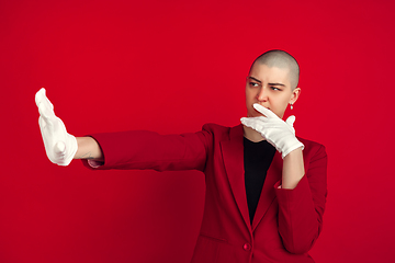 Image showing Portrait of young caucasian bald woman on red background