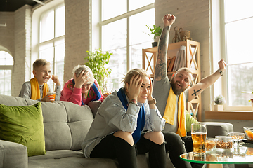 Image showing Excited family watching football, sport match at home, top view