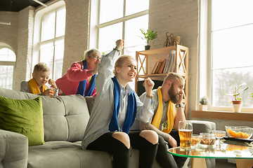 Image showing Excited family watching football, sport match at home, top view