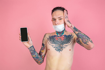 Image showing Portrait of young man with freaky appearance on pink background