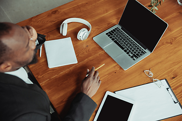 Image showing Top view of businessman or student working from home while being isolated or keep quarantine \'cause of coronavirus COVID-19