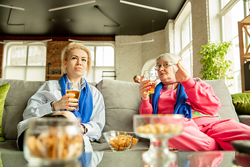 Image showing Excited family watching football, sport match at home, grandma and daughter