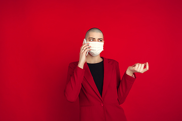 Image showing Portrait of young caucasian bald woman on red background