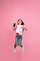 Image showing Caucasian little girl portrait isolated on pink studio background, emotions concept