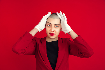 Image showing Portrait of young caucasian bald woman on red background