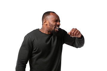 Image showing How coronavirus changed our lives. Young man sneezing on white background