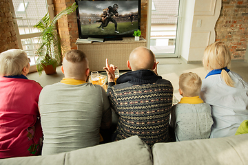 Image showing Excited family watching american football, sport match at home