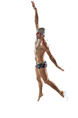 Image showing Professional male swimmer with hat and goggles in motion and action, healthy lifestyle and movement concept