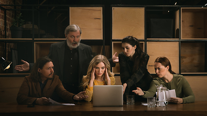 Image showing Young colleagues working together in a office styled like classical artworks. Look busy, attented, cheerful, successful. Concept of business, office, finance.