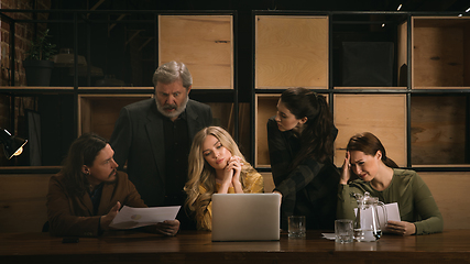 Image showing Young colleagues working together in a office styled like classical artworks. Look busy, attented, cheerful, successful. Concept of business, office, finance.