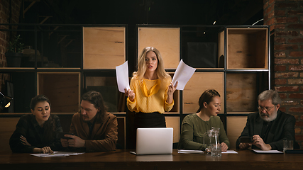 Image showing Young colleagues working together in a office styled like classical artworks. Look busy, attented, cheerful, successful. Concept of business, office, finance.