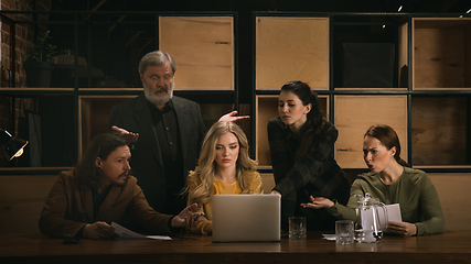 Image showing Young colleagues working together in a office styled like classical artworks. Look busy, attented, cheerful, successful. Concept of business, office, finance.