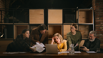 Image showing Young colleagues working together in a office styled like classical artworks. Look busy, attented, cheerful, successful. Concept of business, office, finance.