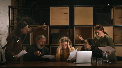 Image showing Young colleagues working together in a office styled like classical artworks. Look busy, attented, cheerful, successful. Concept of business, office, finance.