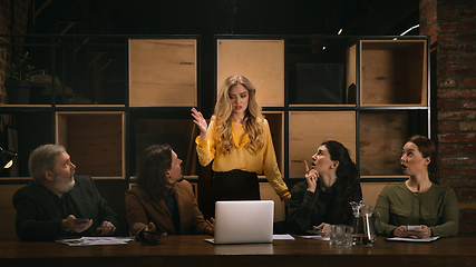 Image showing Young colleagues working together in a office styled like classical artworks. Look busy, attented, cheerful, successful. Concept of business, office, finance.