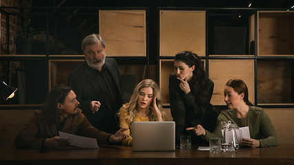 Image showing Young colleagues working together in a office styled like classical artworks. Look busy, attented, cheerful, successful. Concept of business, office, finance.