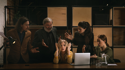 Image showing Young colleagues working together in a office styled like classical artworks. Look busy, attented, cheerful, successful. Concept of business, office, finance.