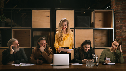 Image showing Young colleagues working together in a office styled like classical artworks. Look busy, attented, cheerful, successful. Concept of business, office, finance.