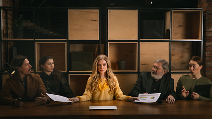 Image showing Young colleagues working together in a office styled like classical artworks. Look busy, attented, cheerful, successful. Concept of business, office, finance.