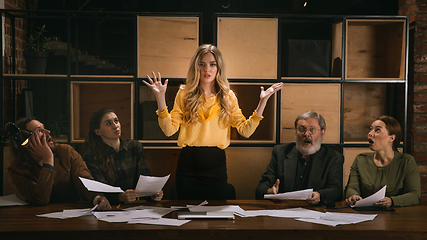 Image showing Young colleagues working together in a office styled like classical artworks. Look busy, attented, cheerful, successful. Concept of business, office, finance.