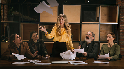 Image showing Young colleagues working together in a office styled like classical artworks. Look busy, attented, cheerful, successful. Concept of business, office, finance.