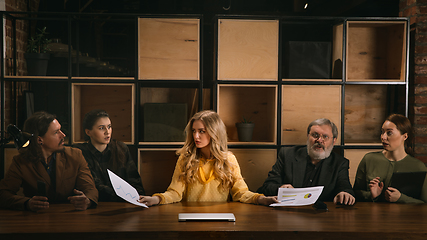 Image showing Young colleagues working together in a office styled like classical artworks. Look busy, attented, cheerful, successful. Concept of business, office, finance.